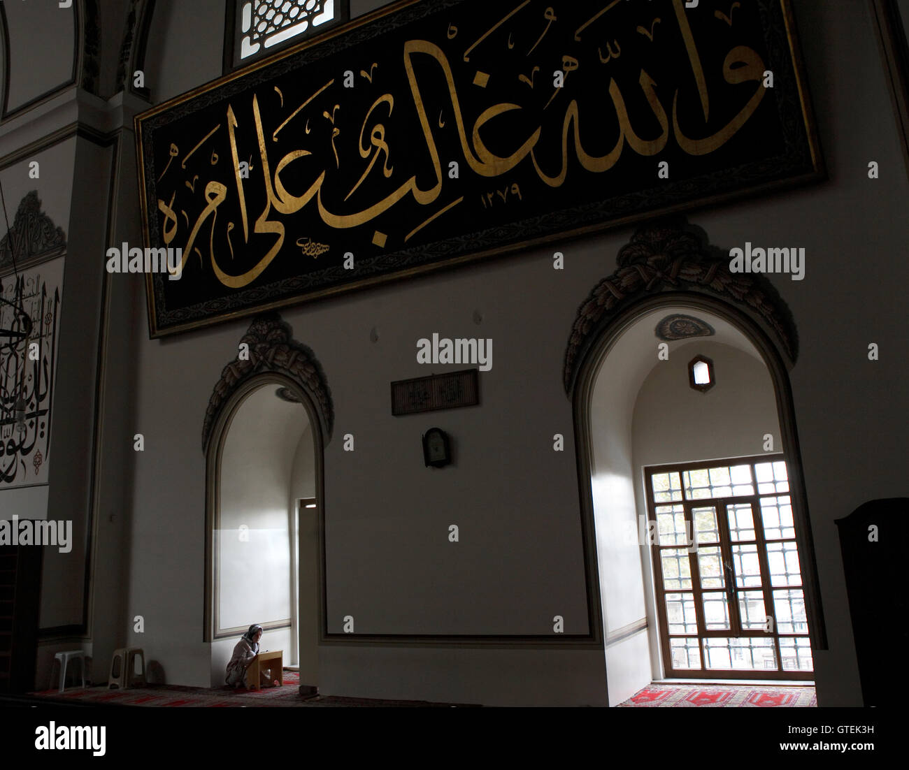 'Istanbul #1' Mosque interior. Woman worshiper in background. Stock Photo