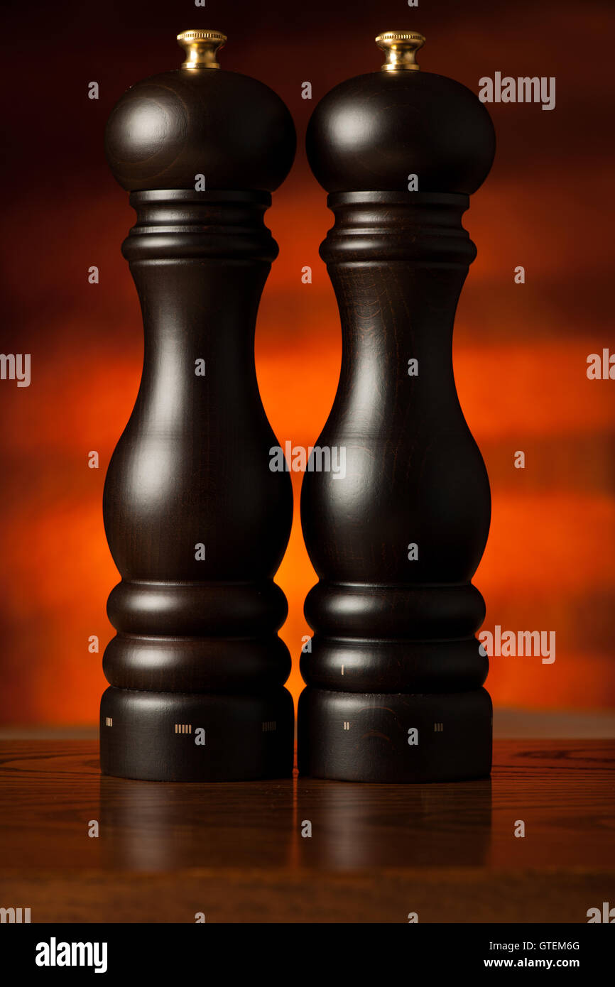 Stylish wooden salt and pepper mill on a rustic table in restaurant
