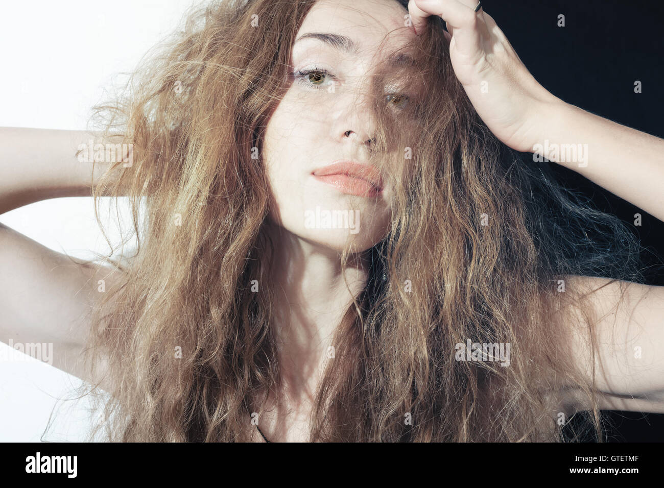 Portrait of a beautiful young woman with long curly hair Stock Photo ...