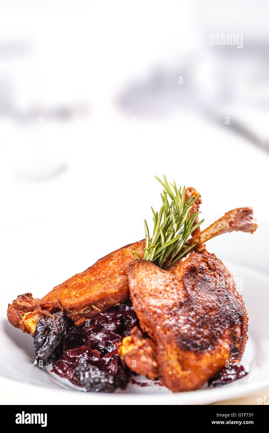 Roasted duck drumstick with braised red cabbage, copy space Stock Photo