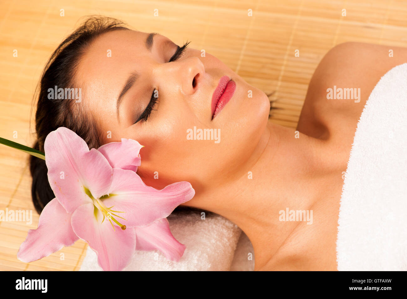 Beautiful young woman having a face massage in wellness studio - spa Stock Photo