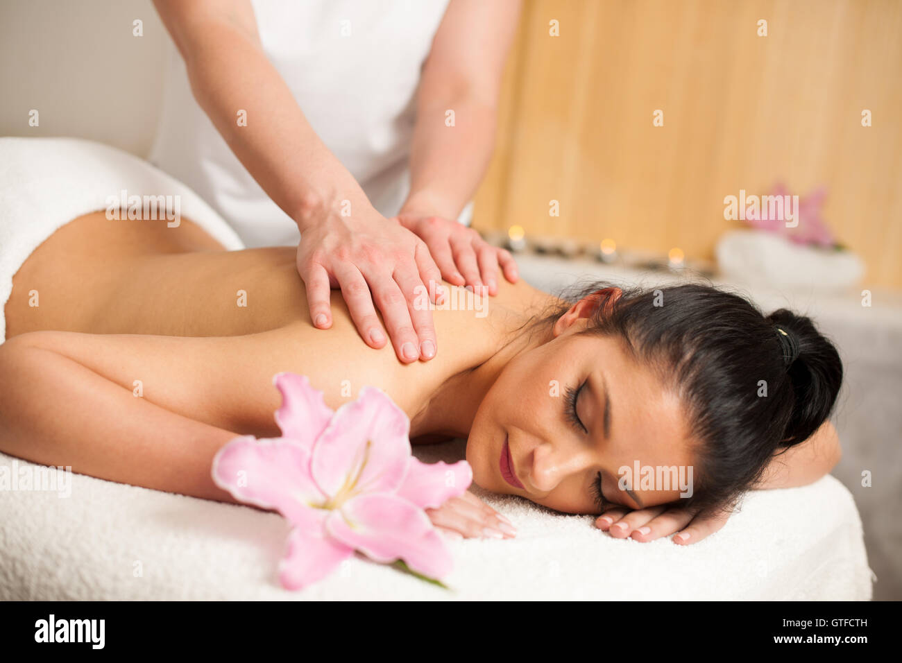 Beautiful young woman having a rejuvenating massage in a wellness studio - spa Stock Photo