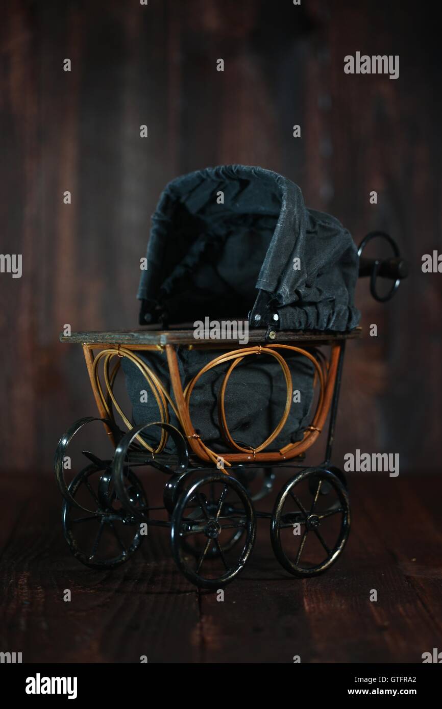 Baby Cradle on Grunge Wooden Background Stock Photo