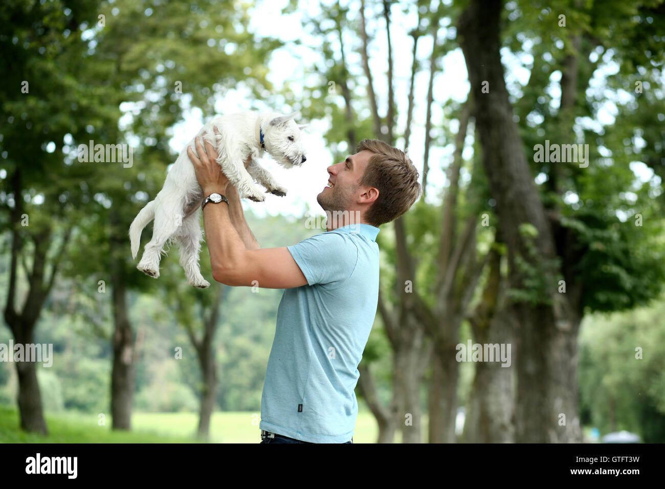 Young man and his adorable little dog Stock Photo