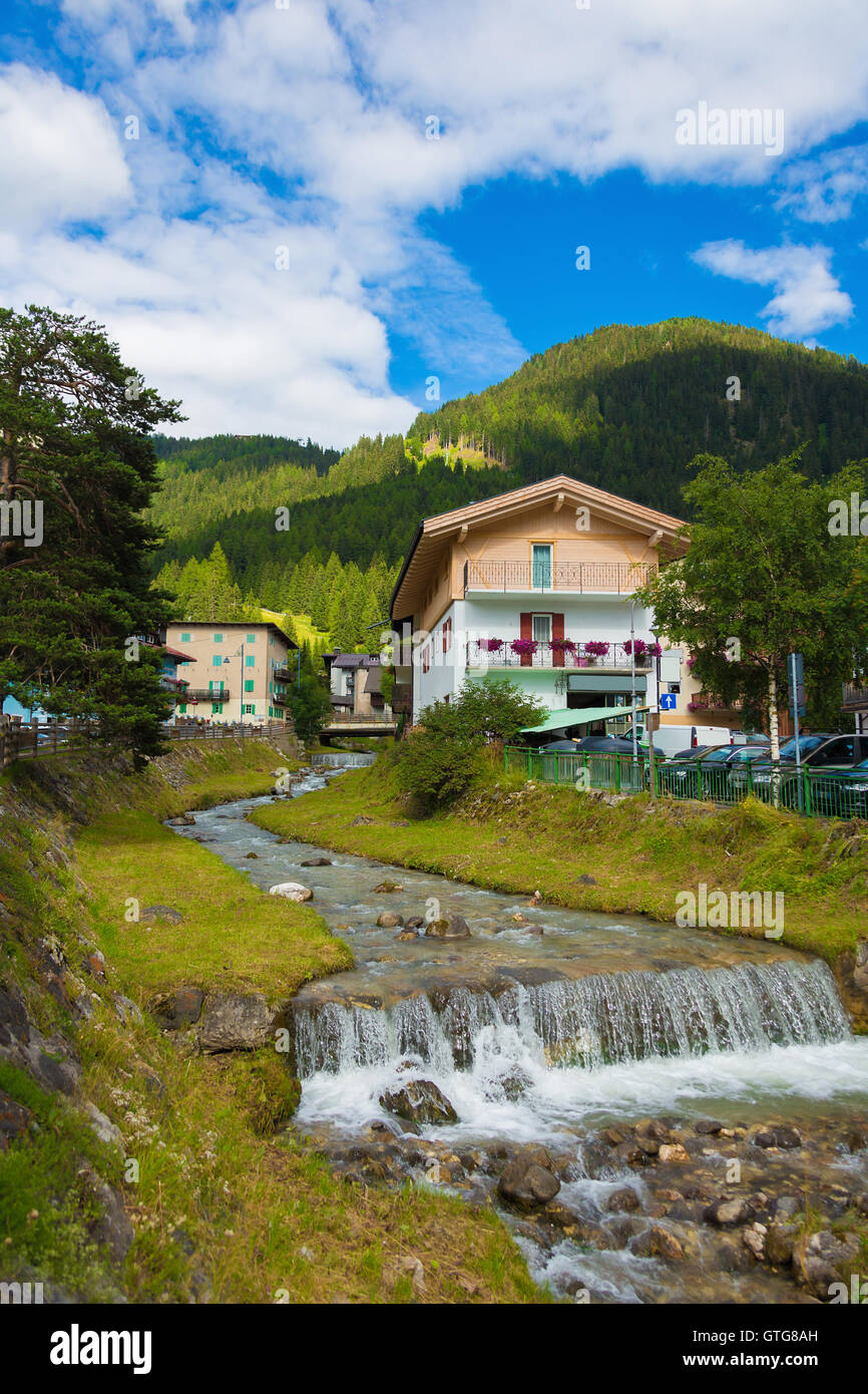 mountain river flowing through village in the Alps Stock Photo