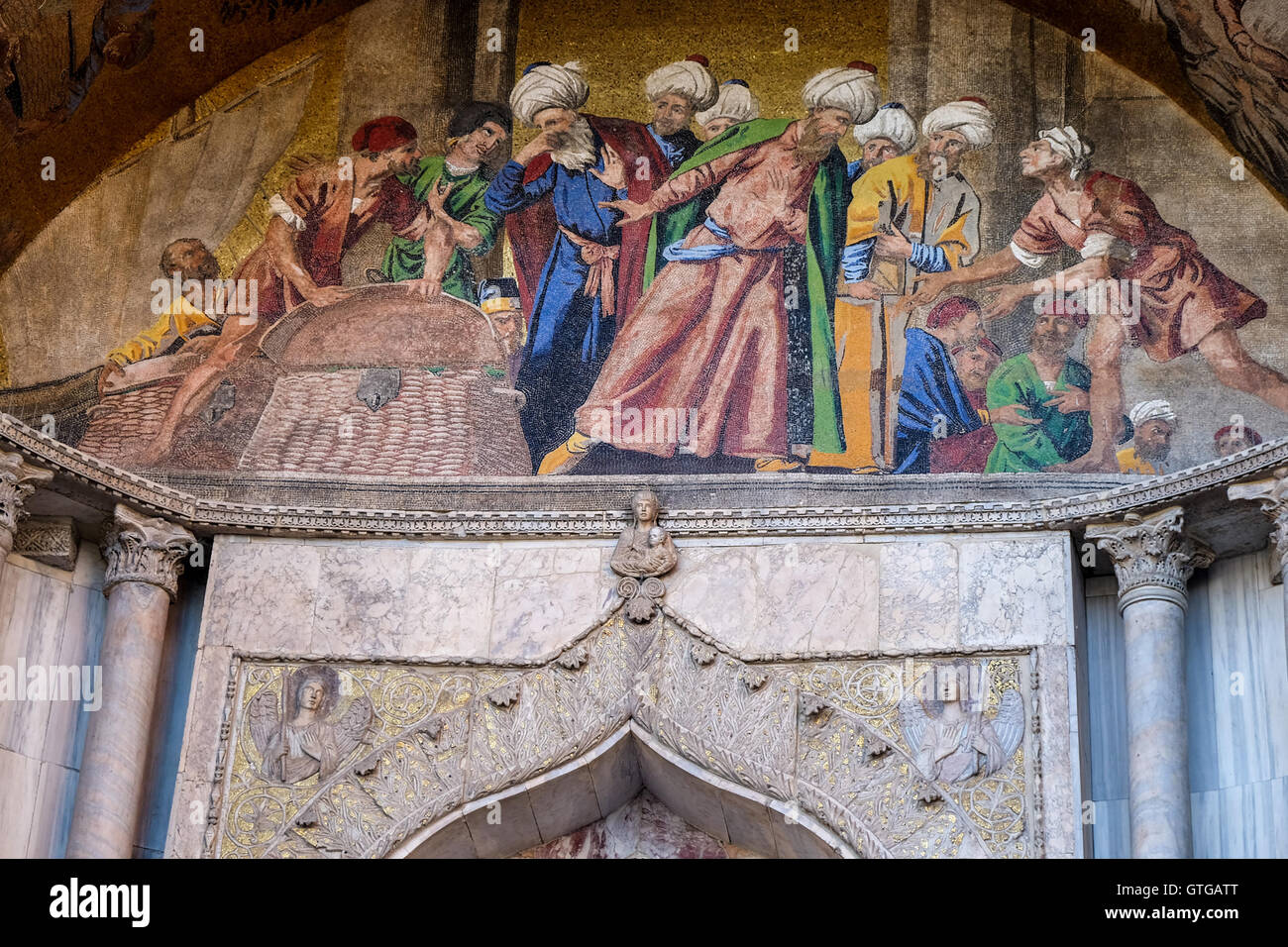 Mosaic on the facade of st Marks basilica with scenes showing the history of the relics of Saint Mark, Venice Italy Stock Photo
