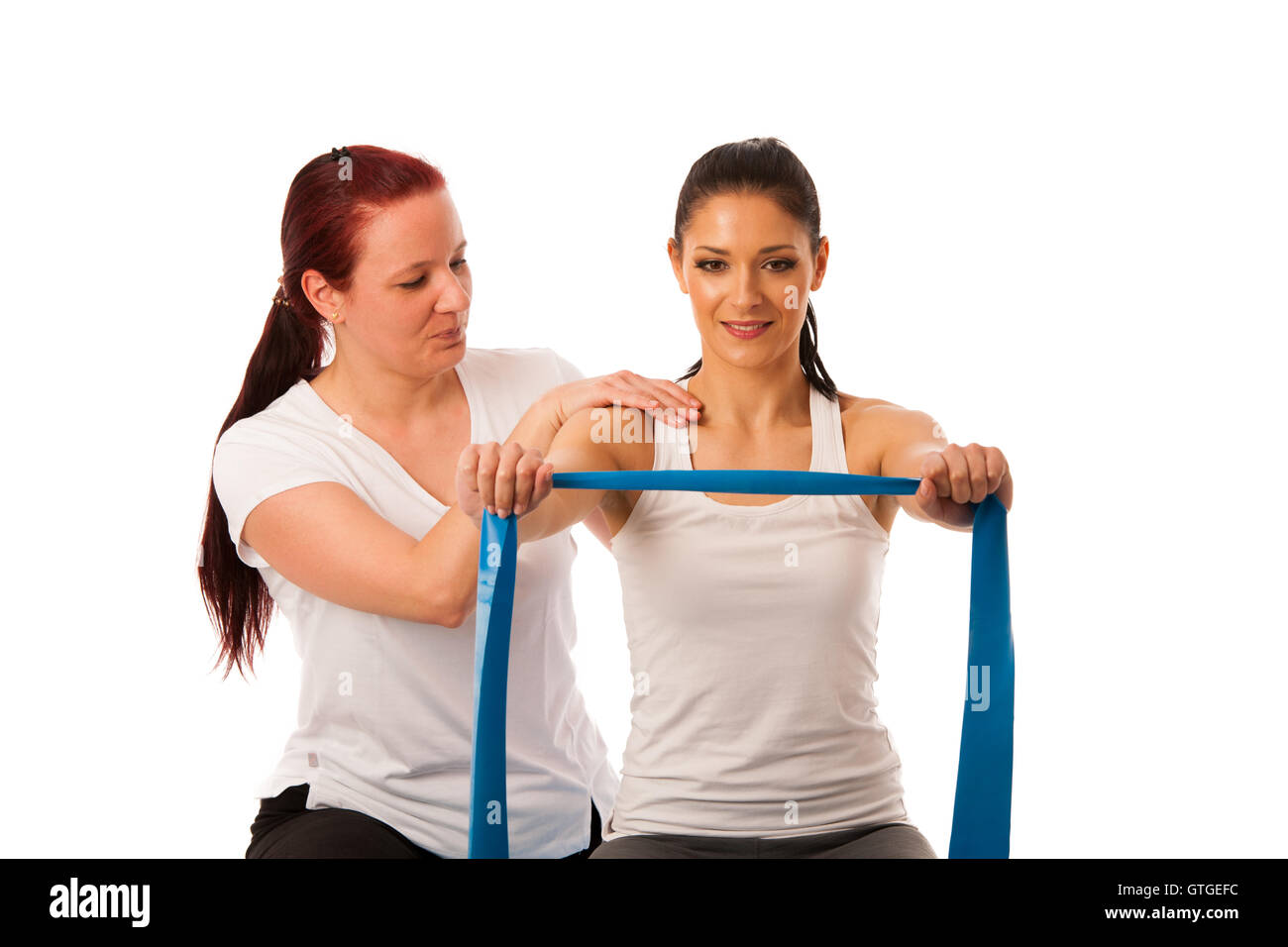 Physiotherapy - therapist doing arm straightening exercises with a patient to recover strength after injury Stock Photo