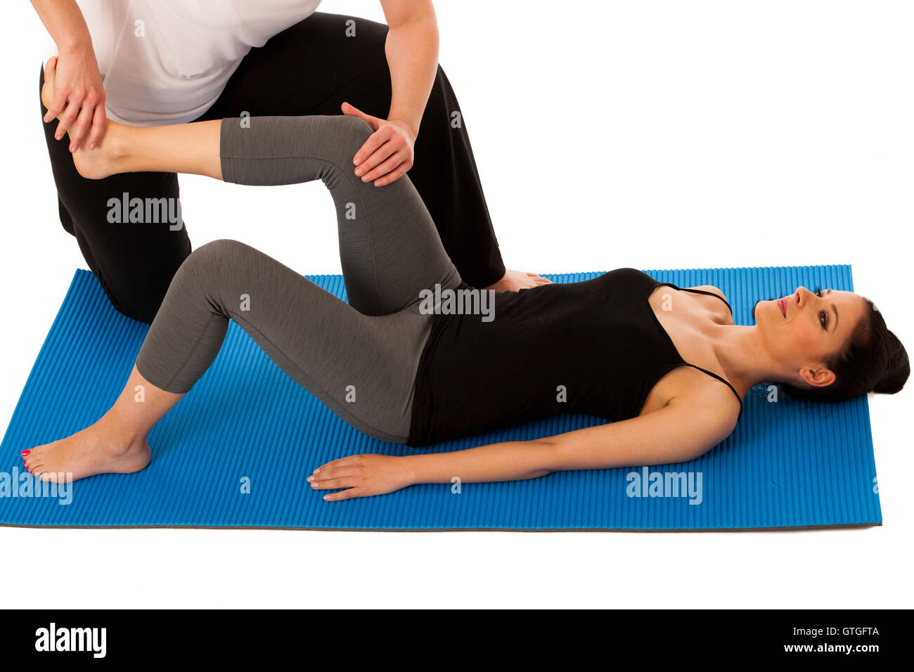 Physiotherapy - therapist doing   leg stretching exercises with a patient to recover  after injury isolated Stock Photo