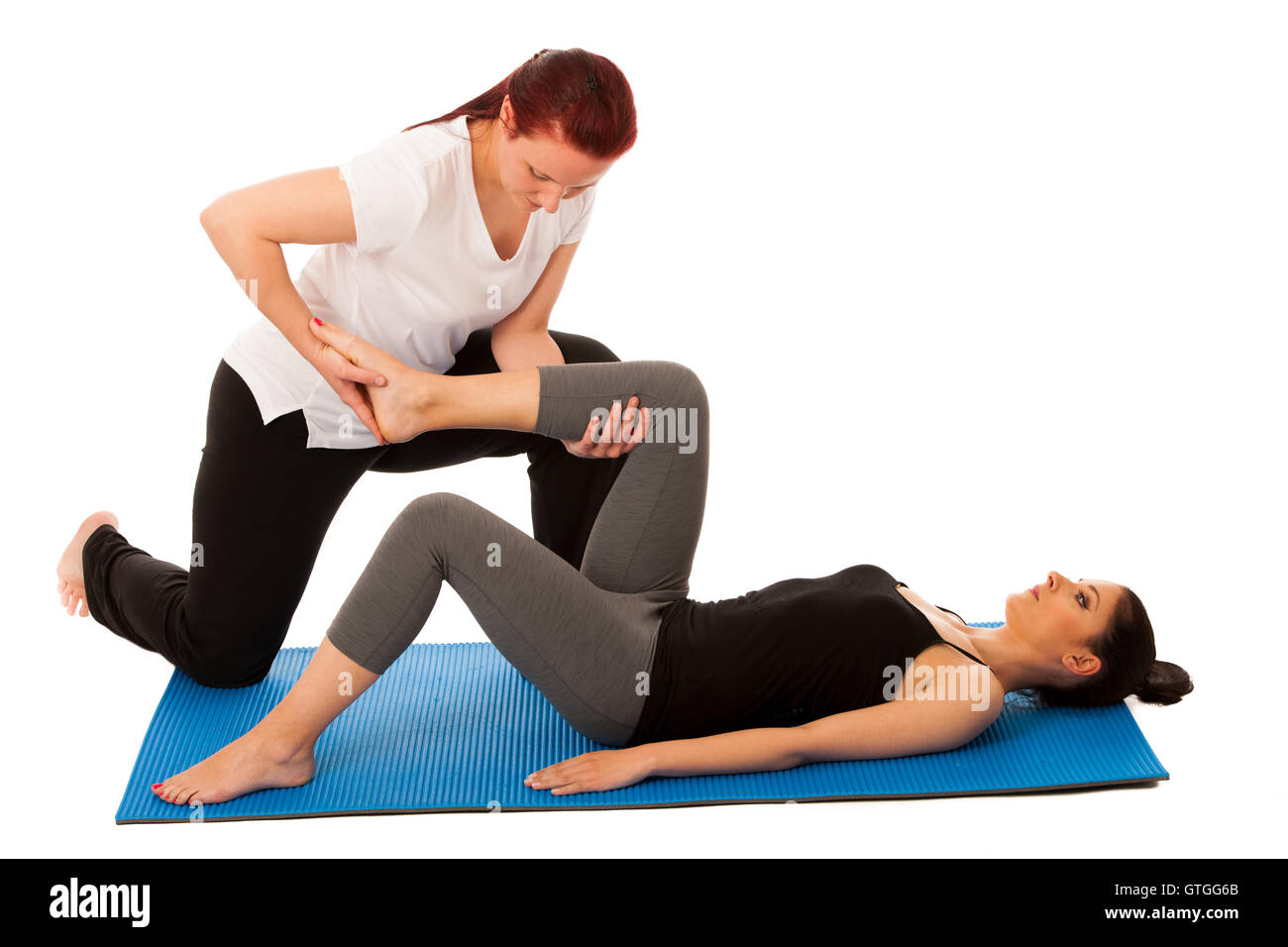Physiotherapy - therapist doing   leg stretching exercises with a patient to recover  after injury isolated Stock Photo