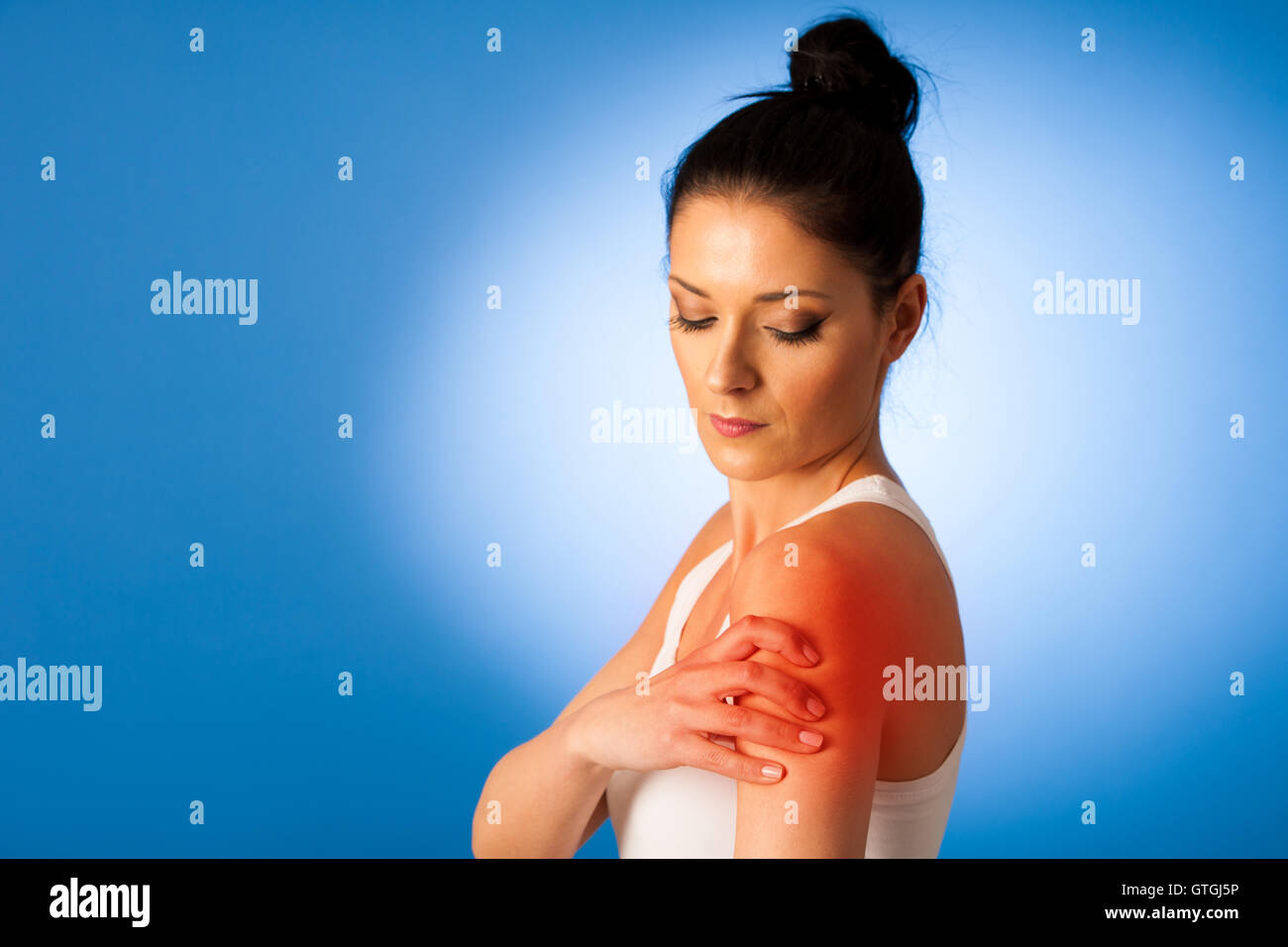 Beautiful woman having pain in her shoulder - injury Stock Photo