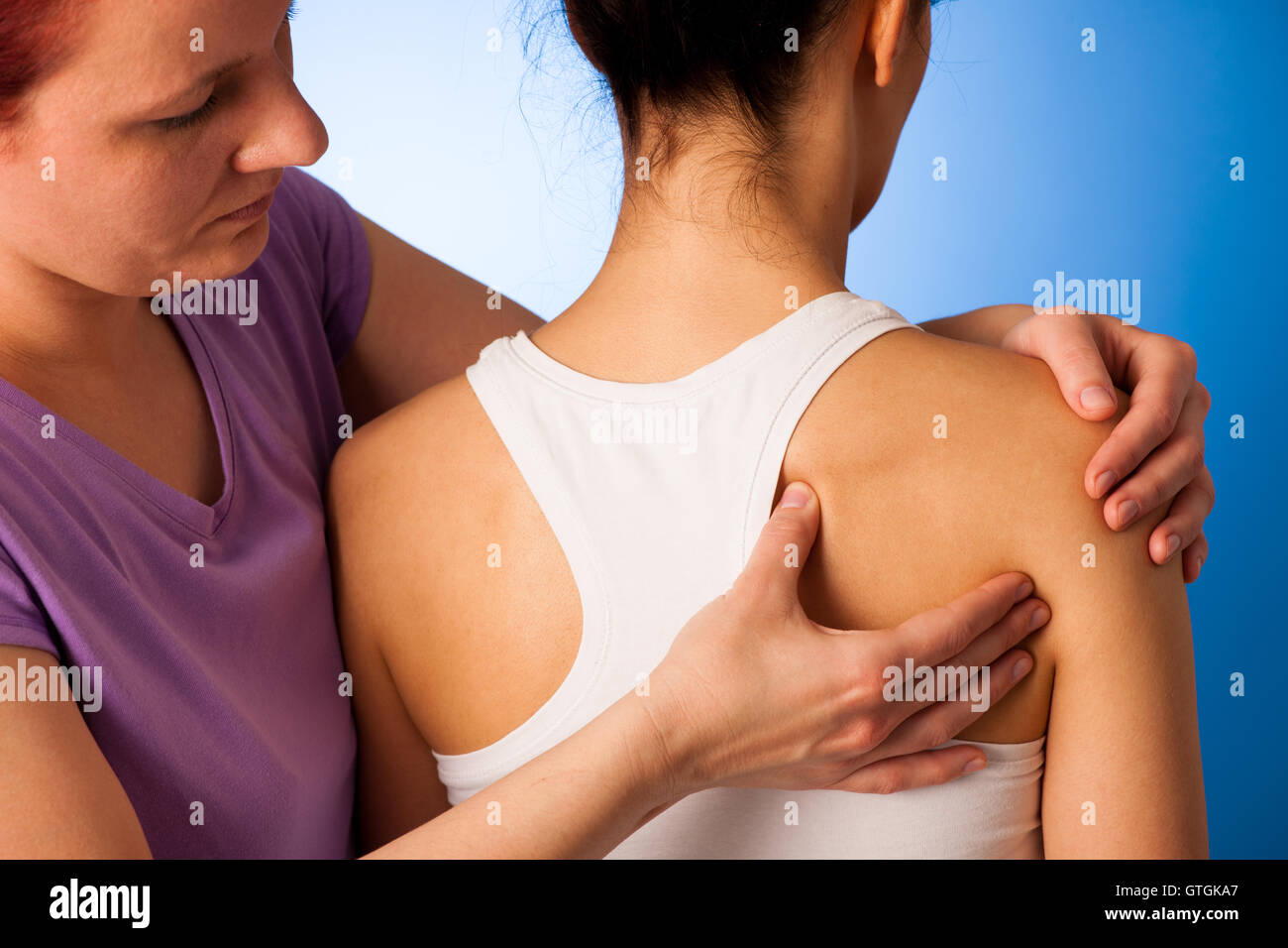 physio therapist helping Woman having pain in her back - back injury Stock Photo