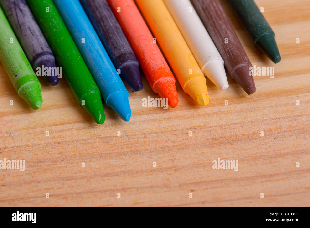 Wax crayons on a wooden background Stock Photo - Alamy