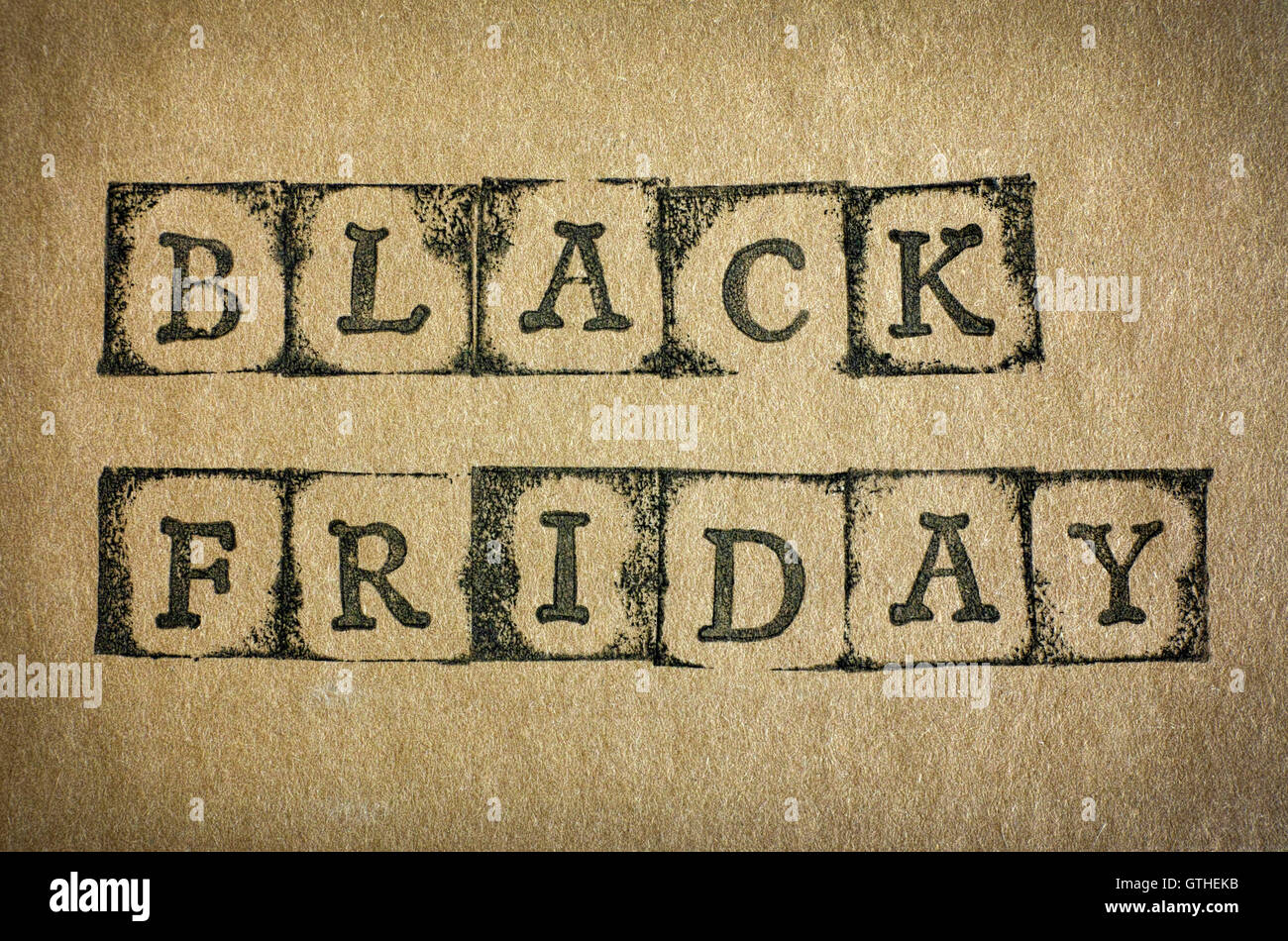 Words Black Friday make by black alphabet stamps on cardboard. Stock Photo