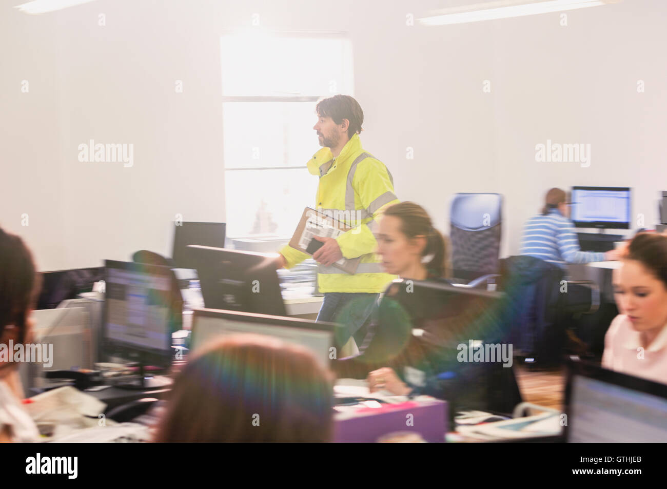 Deliveryman delivering package in office Stock Photo