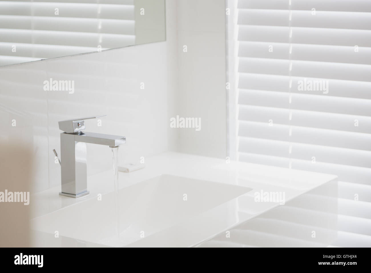 Modern white bathroom sink and faucet in home showcase interior Stock Photo