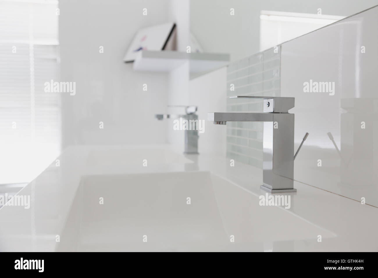 Modern white bathroom sink and faucet in home showcase interior Stock