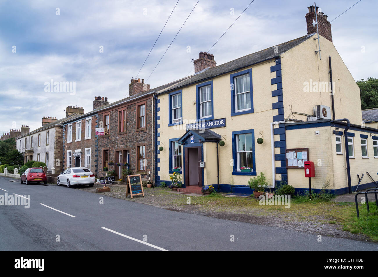 Hope & Anchor pub exterior and Georgian terraced houses, Port Carlisle, Cumbria, England in summer Stock Photo