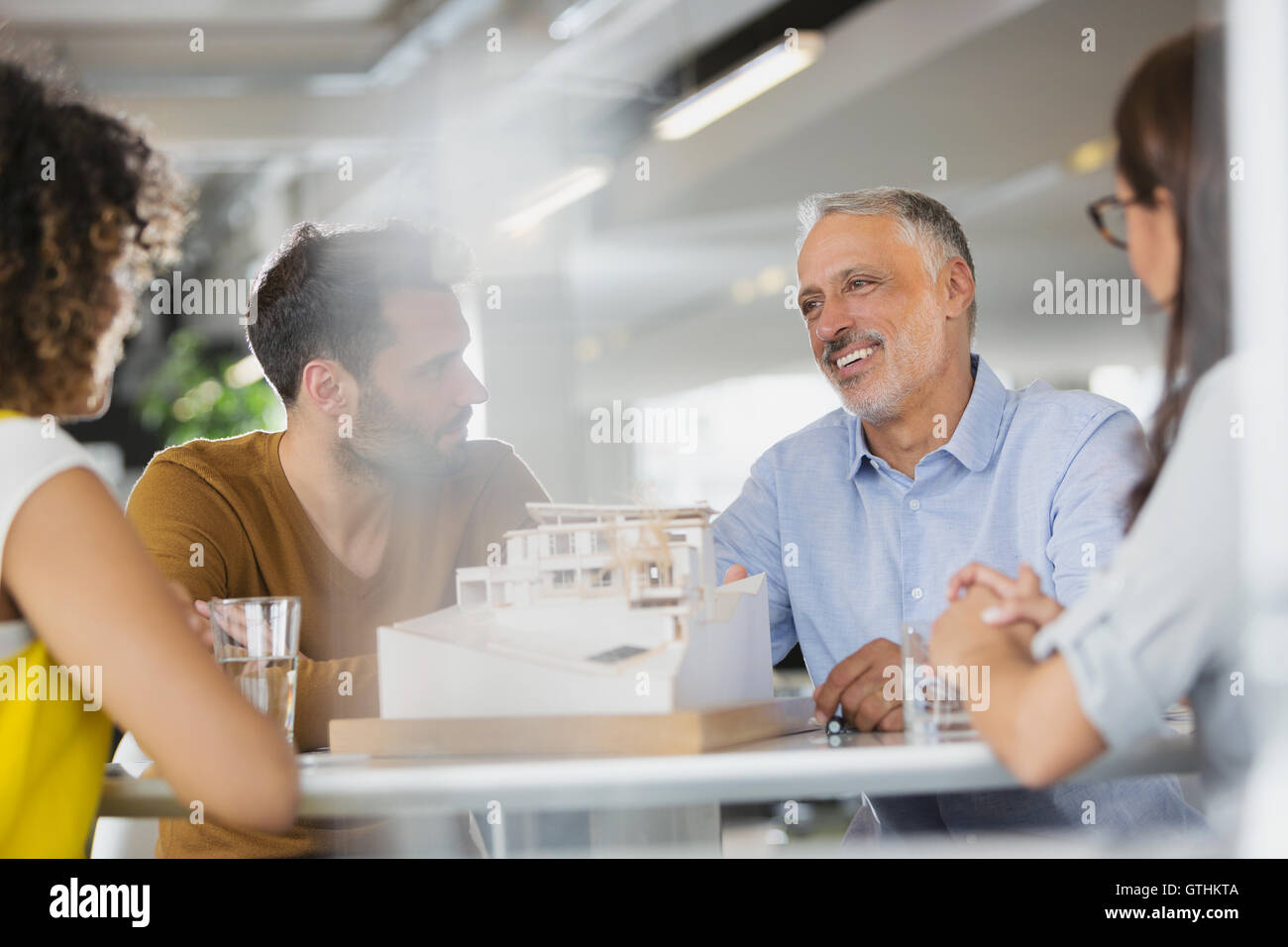 Architects with model meeting in office Stock Photo - Alamy
