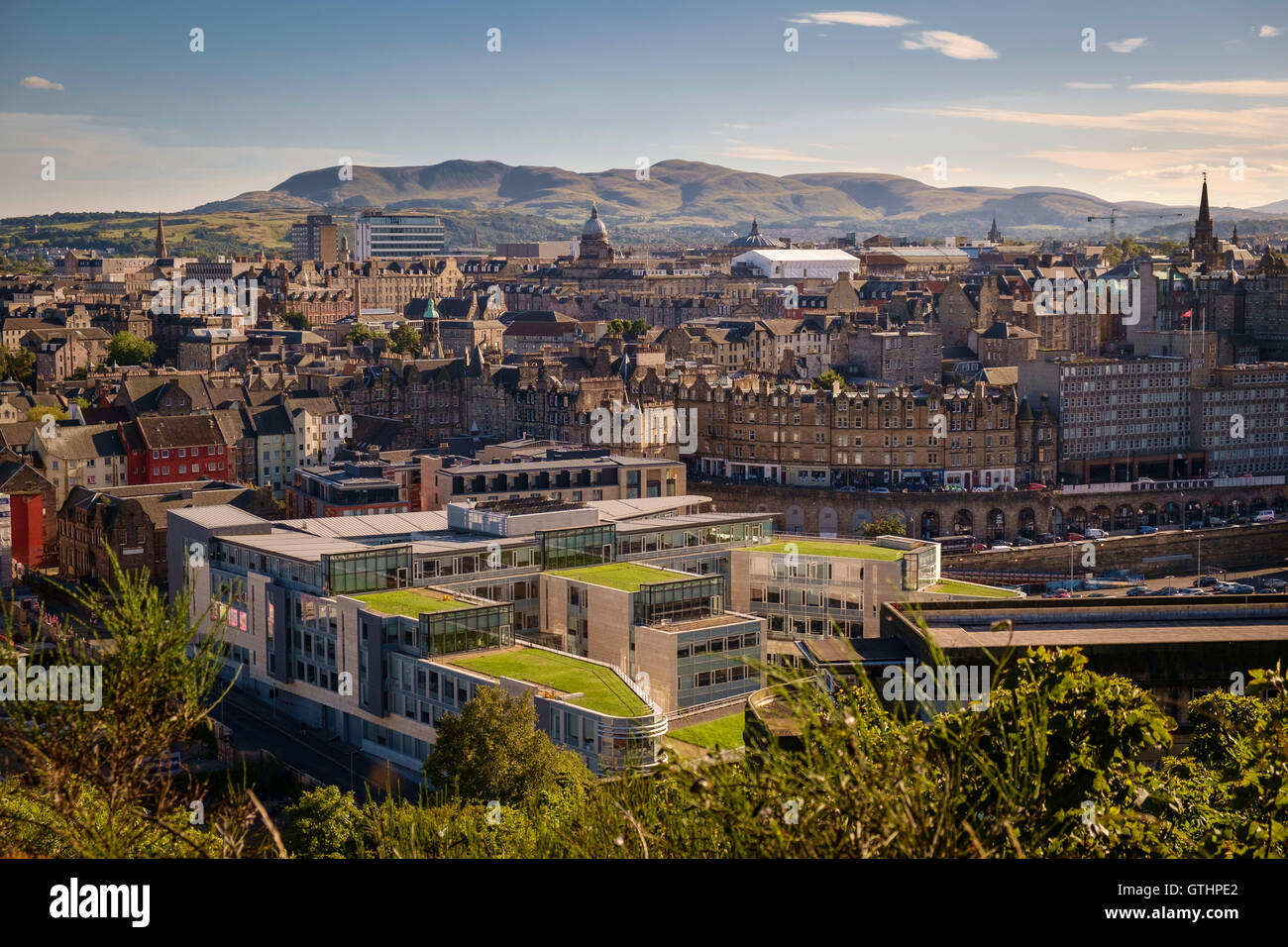 Grass covered roofs of the City of Edinburgh Council building with the Pentland Hills in the background. Stock Photo