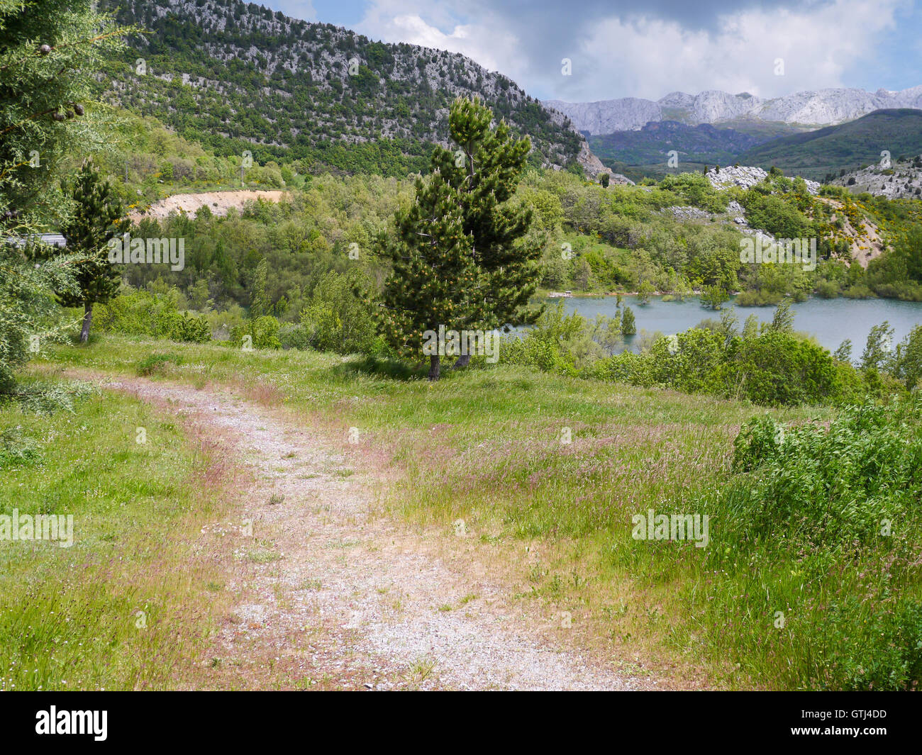 Walking path along the lake in the mountains Stock Photo