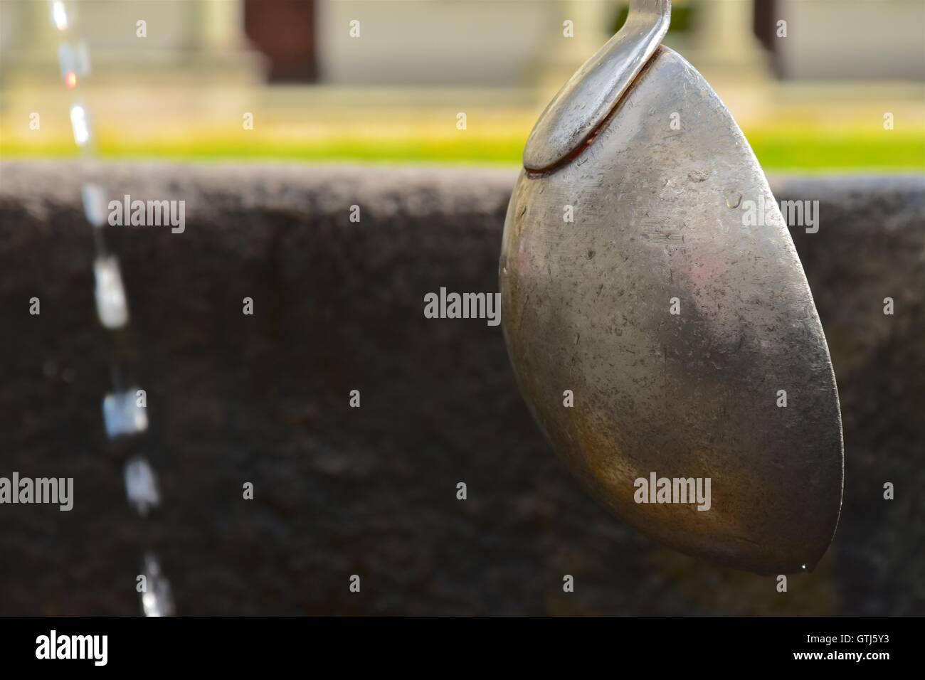 Ornamental fountain with ladles in an elegant Italian garden. Piedmont