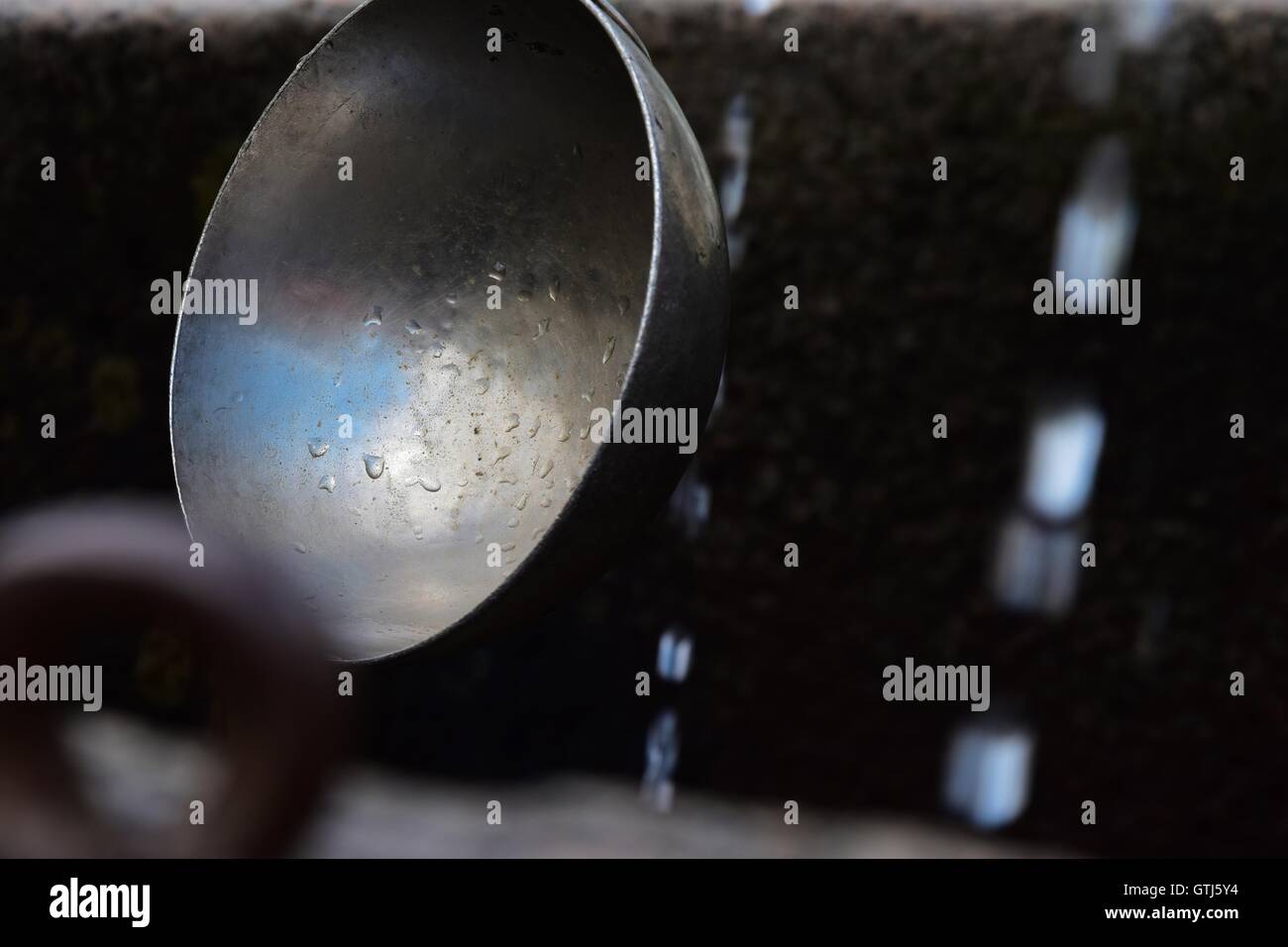 Ornamental fountain with ladles in an elegant Italian garden. Piedmont