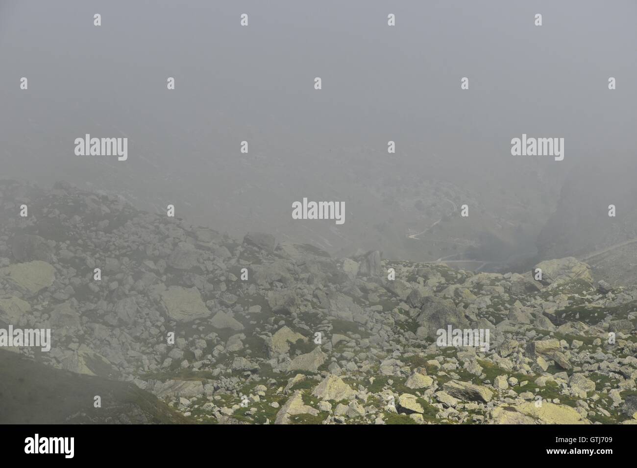 Beautiful mountains and valleys with steep rocks, paths and fog form