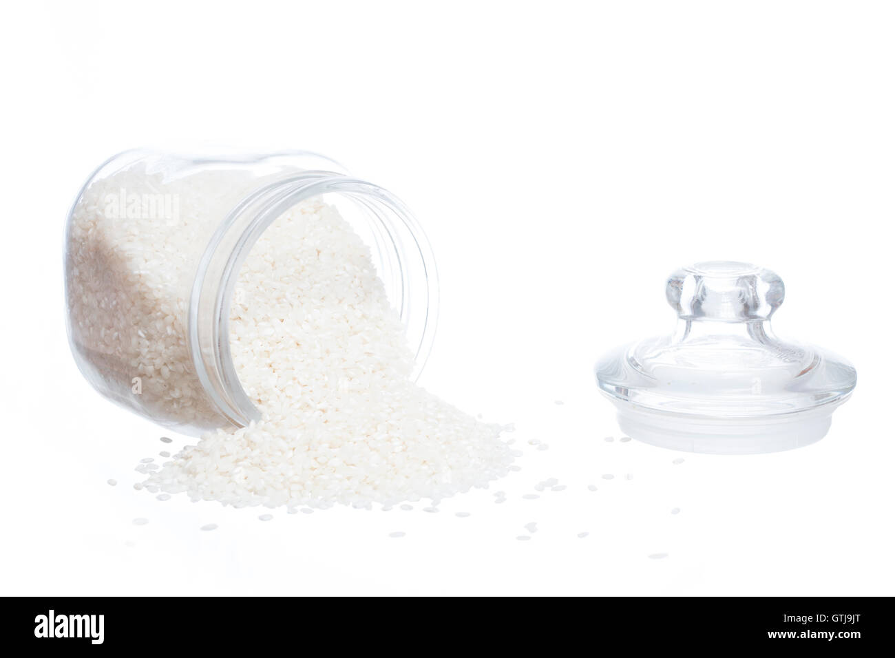 Closeup of rice jar spilled isolated on white background Stock Photo