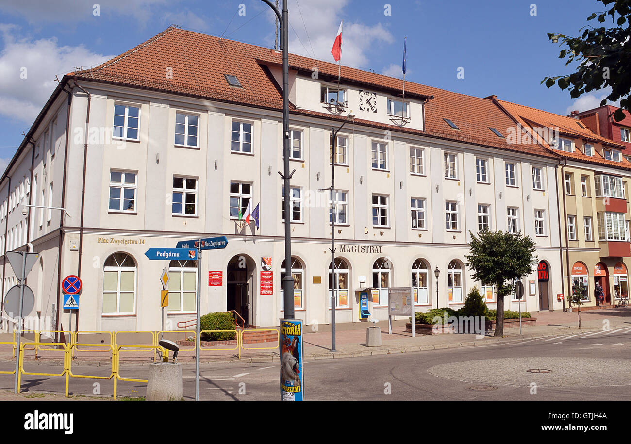 The Magistrat (Municipal Buildings) in the market square (Plac Zwyciestwa) in Goldap, Poland. Stock Photo
