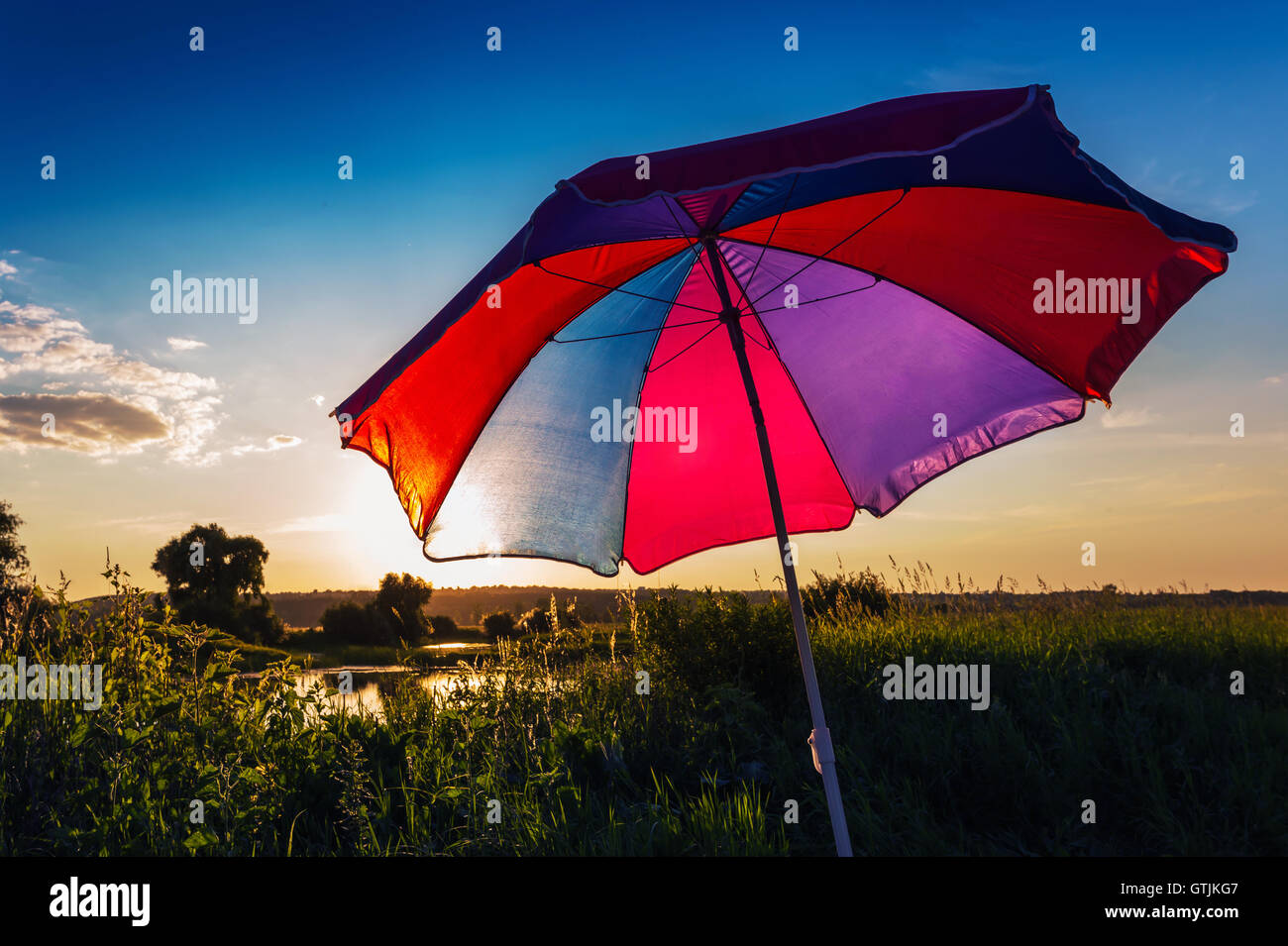 Colorful umbrella in the summer at sunset Stock Photo