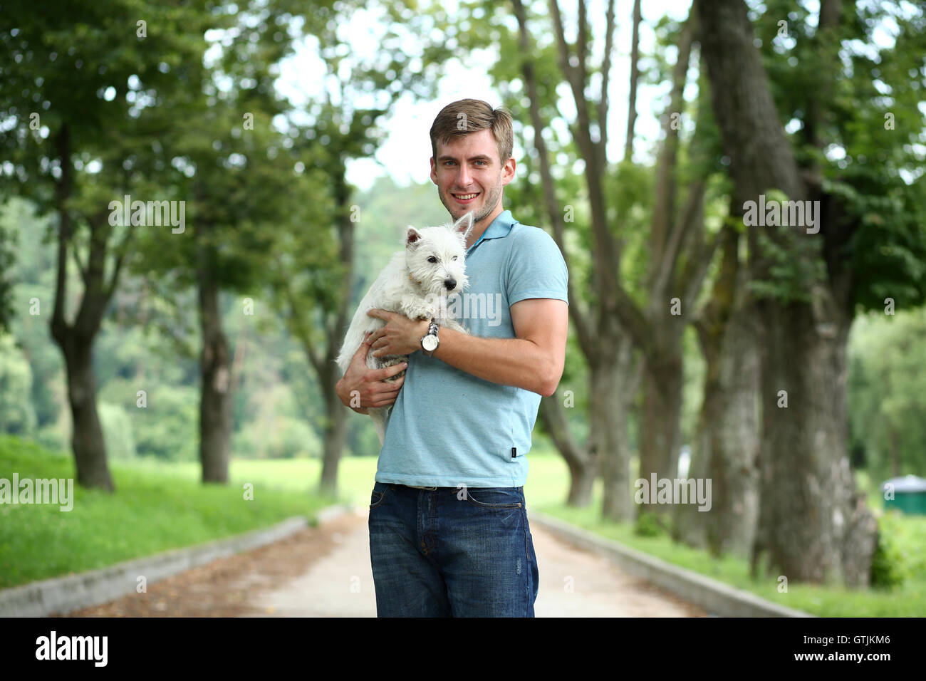 Young man and his adorable little dog Stock Photo