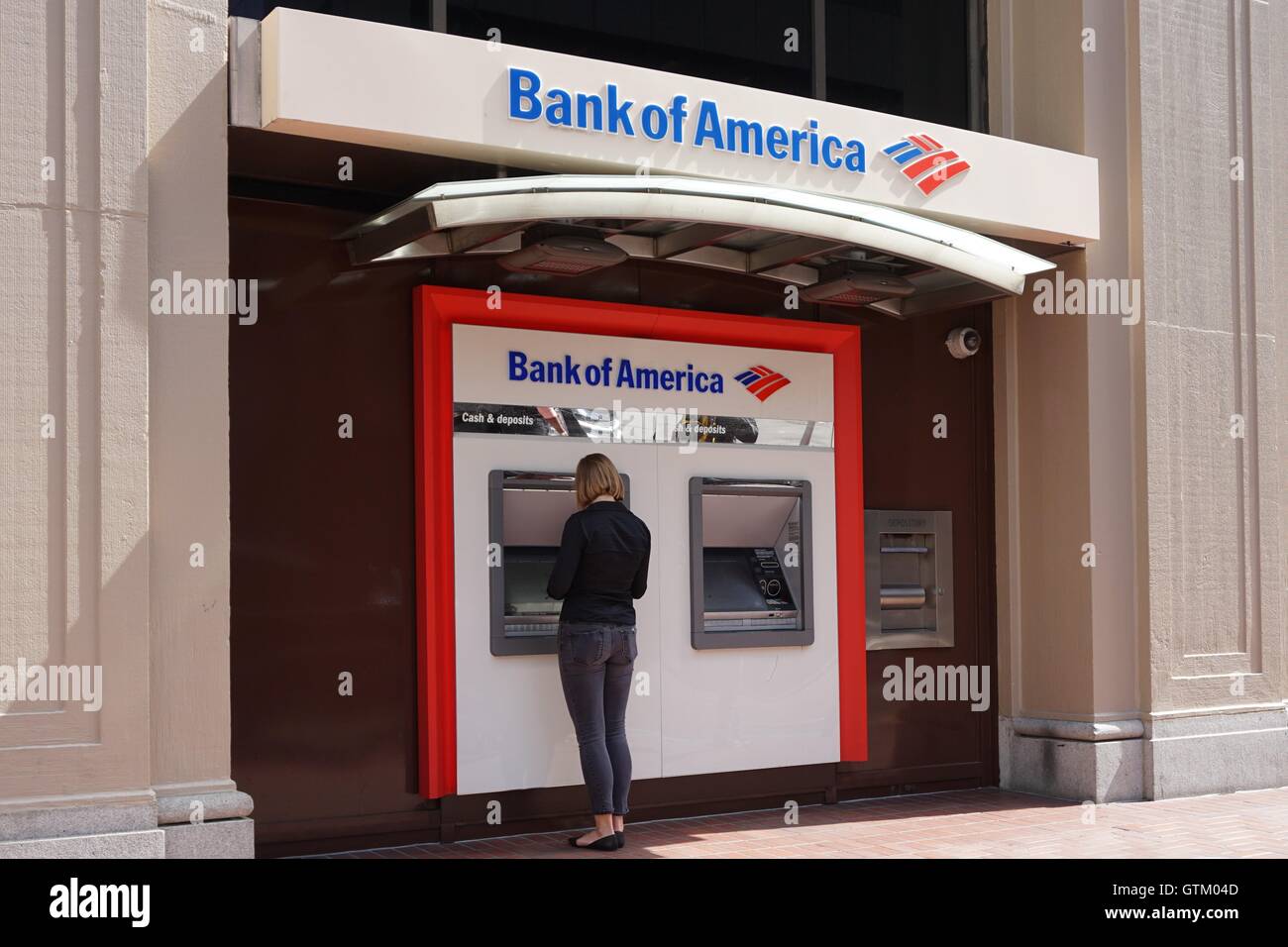 A Woman Stands At A Bank Of America Atm Machine Bank Of America Branch