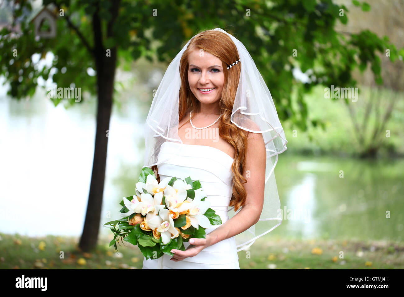 Beautiful red hair bride wearing wedding dress Stock Photo