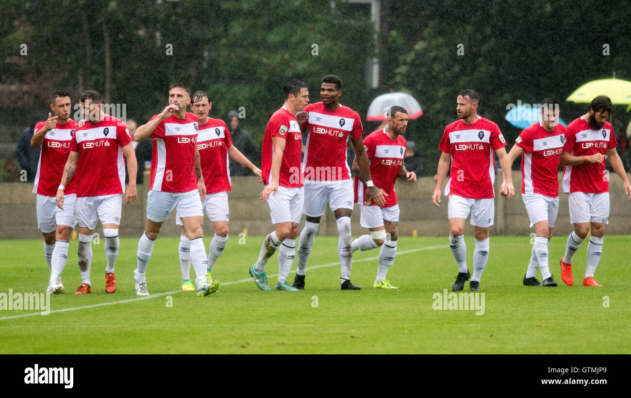 All ten Salford City outfield players celebrate a goal together Stock Photo
