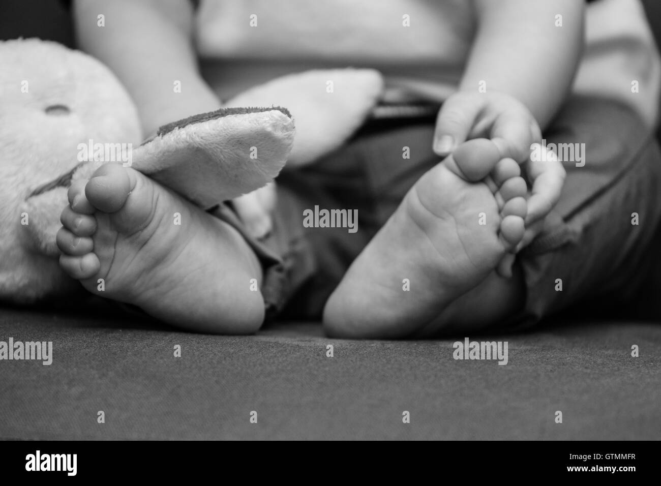 Adorable tiny baby feet. Stock Photo