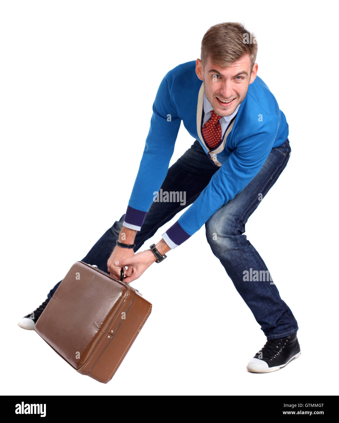 A young man carrying a suitcase Stock Photo Alamy