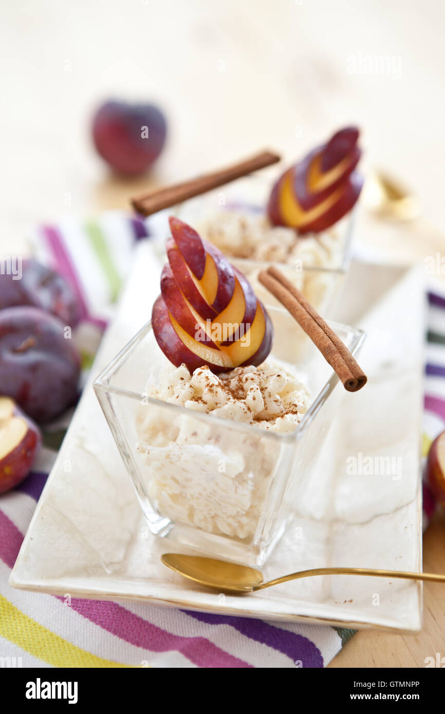 Rice pudding with cinnamon and plums Stock Photo Alamy