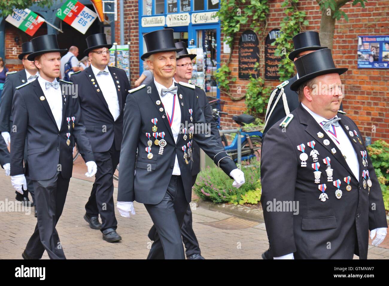 Men in black suits wearing their decorations in Steinhude, Germany