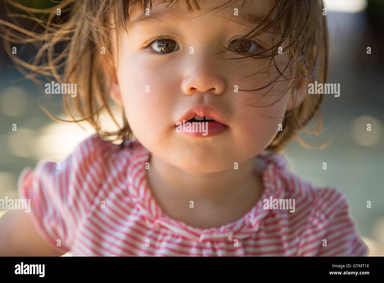 Dreamy expression of two year old toddler girl Stock Photo