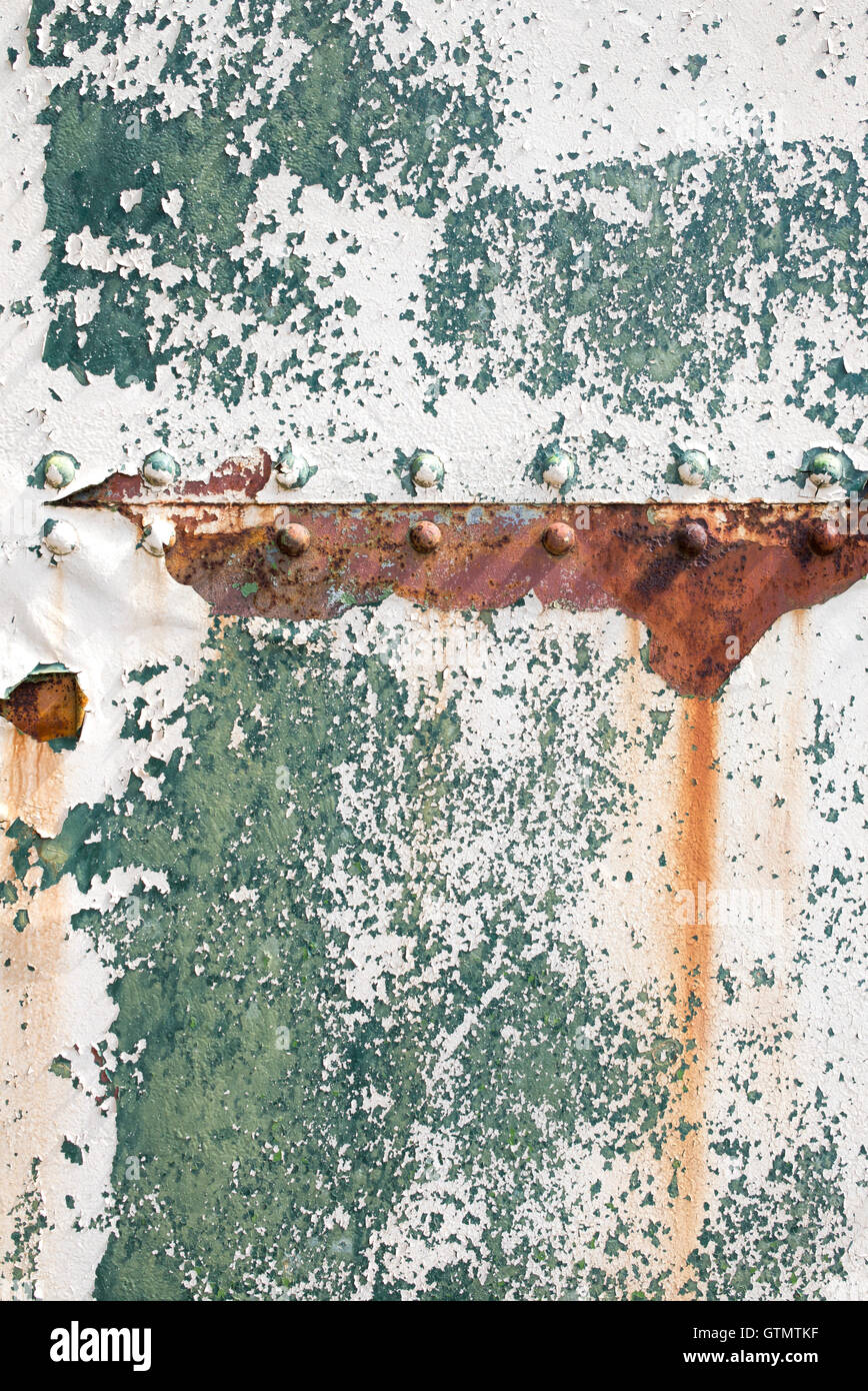 Peeling paint rust and rivets texture. Old metal garage door Stock