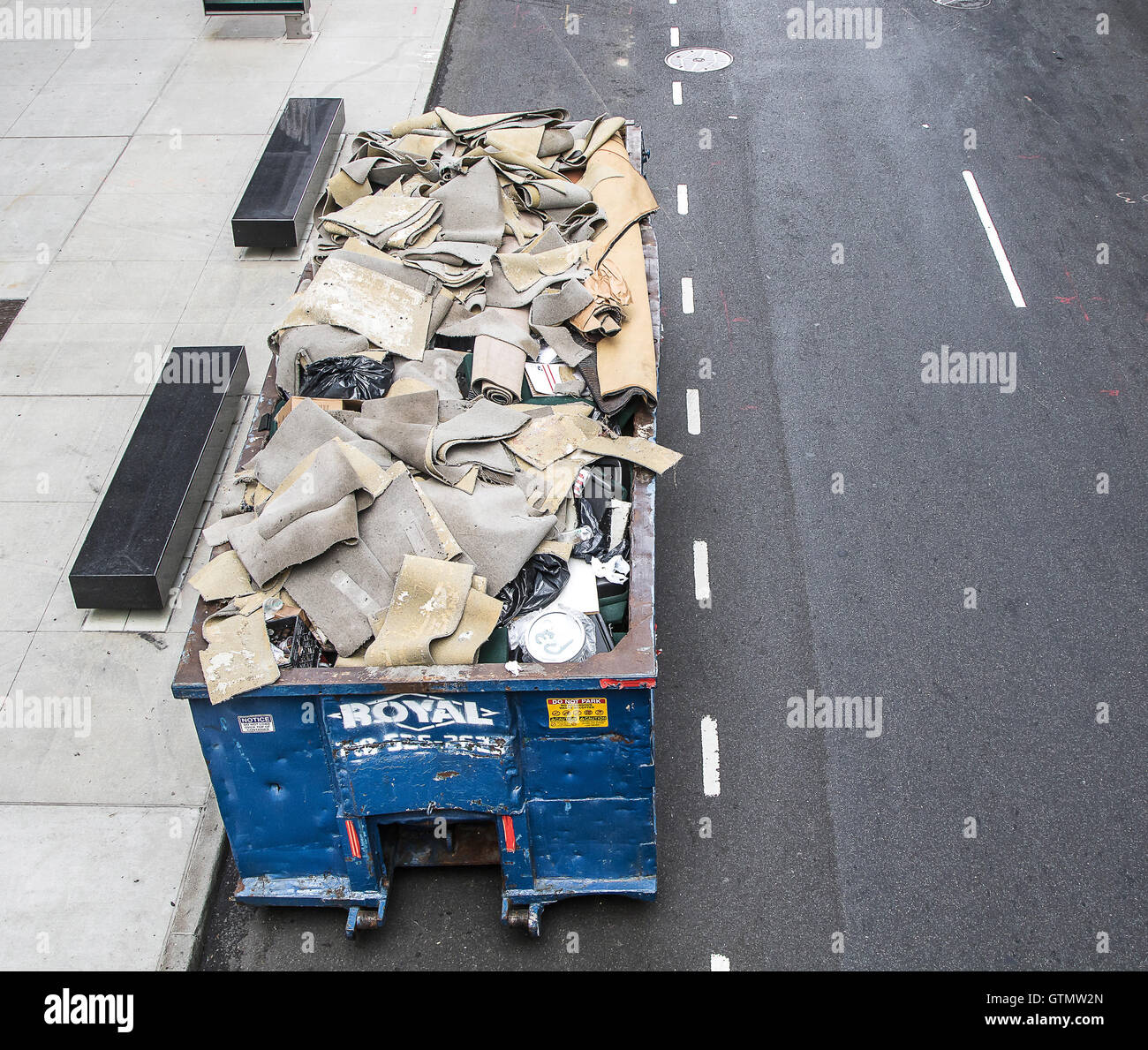 A full dumpster in the street in New York City. Stock Photo
