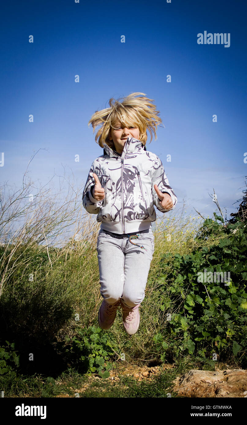Girl jumping for joy hi-res stock photography and images - Alamy