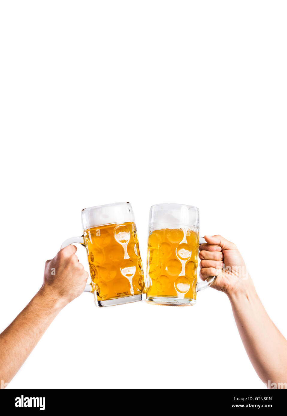 Two unrecognizable men clinking with beer mugs, studio shot Stock Photo ...