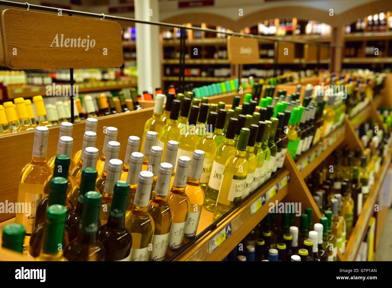 Bottles of wine on shelves in store Stock Photo