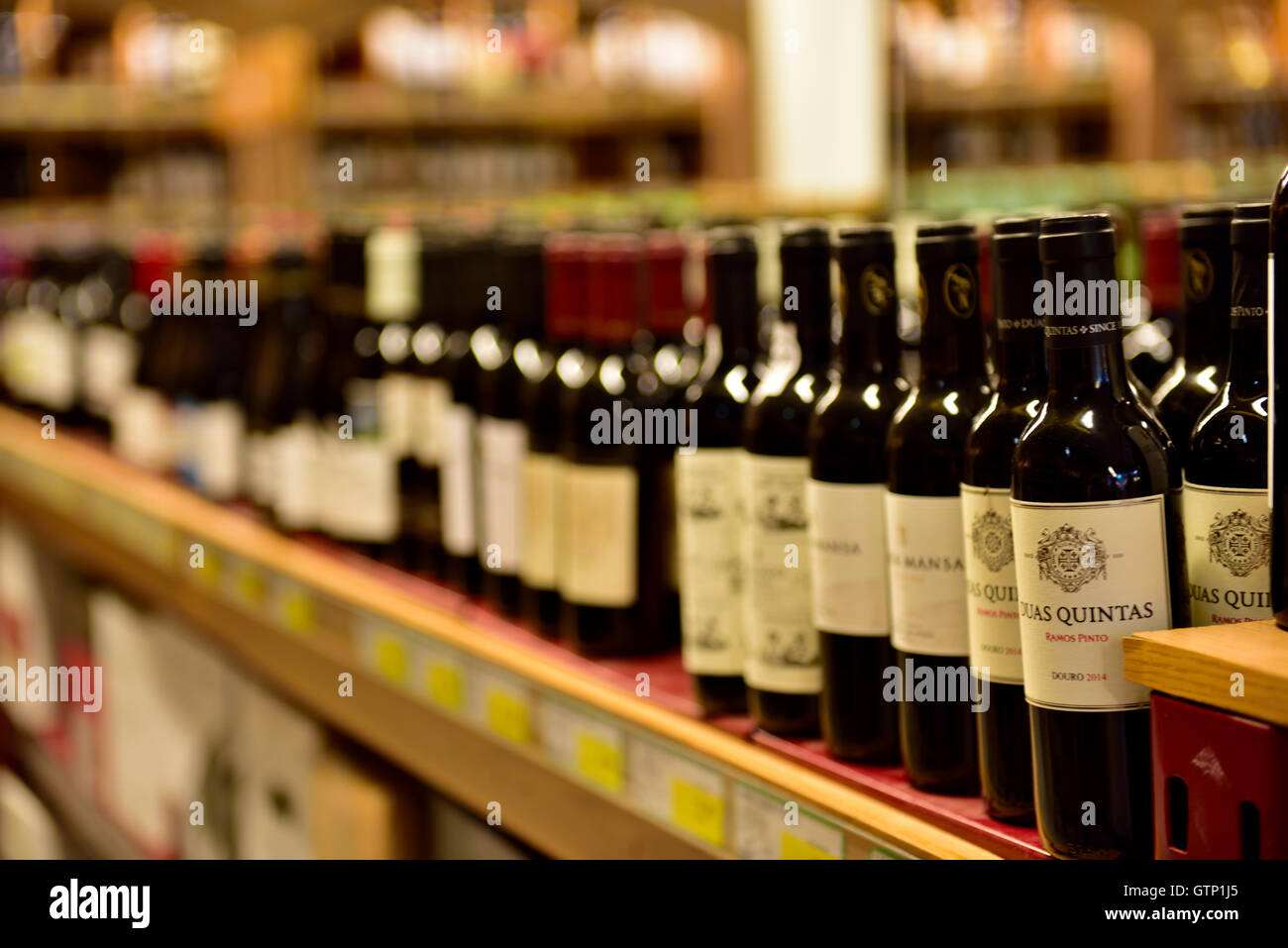 Bottles of wine on shelves in store Stock Photo
