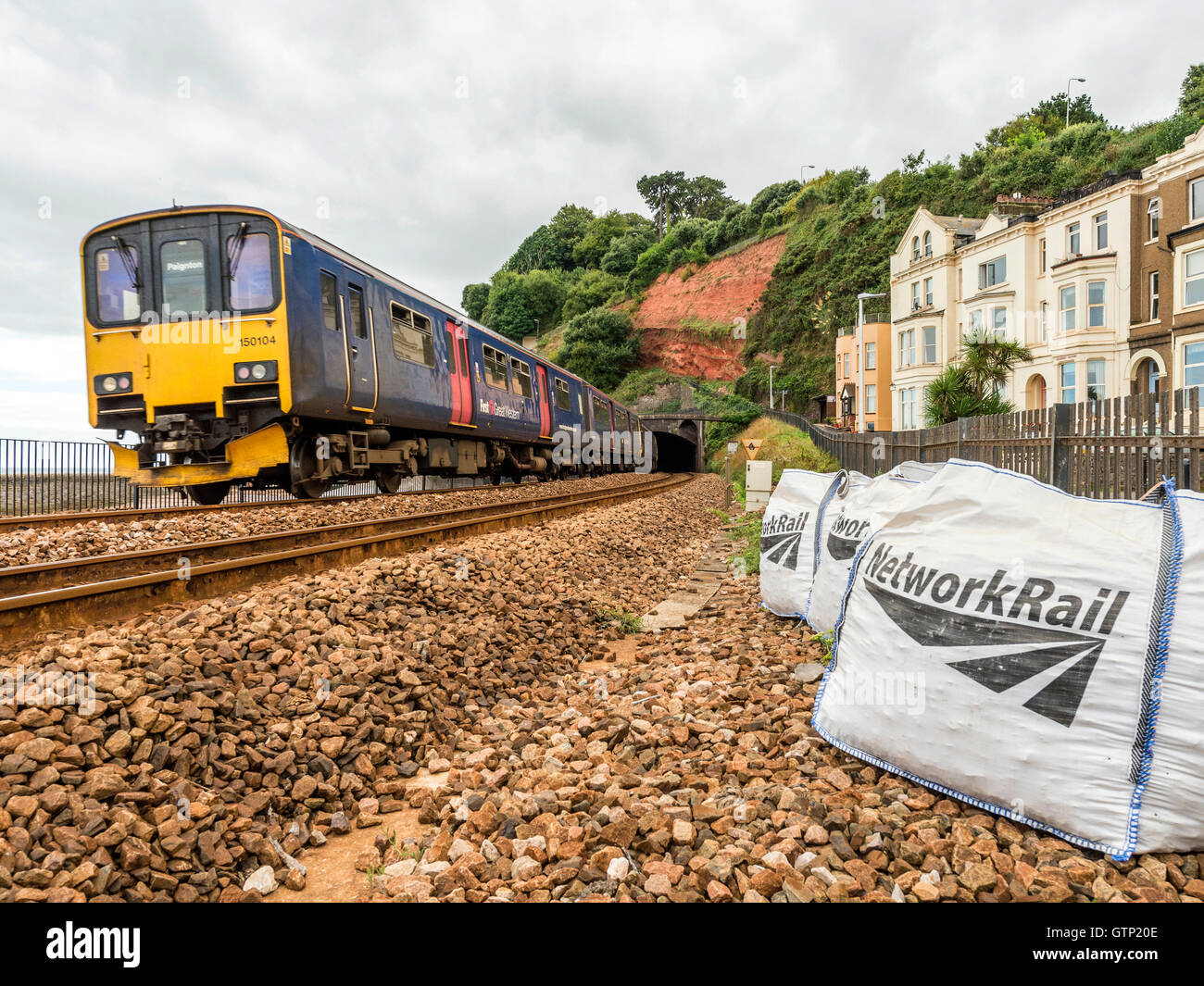 Landscape depicting the picturesque First Great Western Riviera railway line at Dawlish, with approaching train. Stock Photo