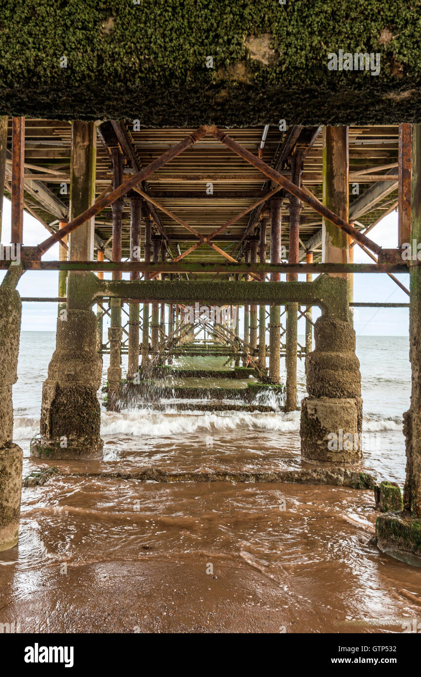 Landscape depicting the seashore along Teignmouth beach at Teignmouth, with views of the Grand Pier structure. Stock Photo