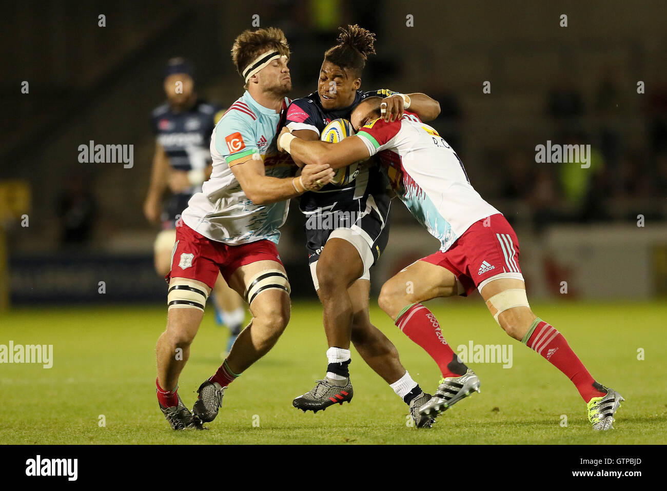 Sale Sharks Paolo Odogwu is tackled by Harlequins Jack Clifford (left) and Ross Chisholm (right), during the Aviva Premiership match at the AJ Bell Stadium, Salford Stock Photo