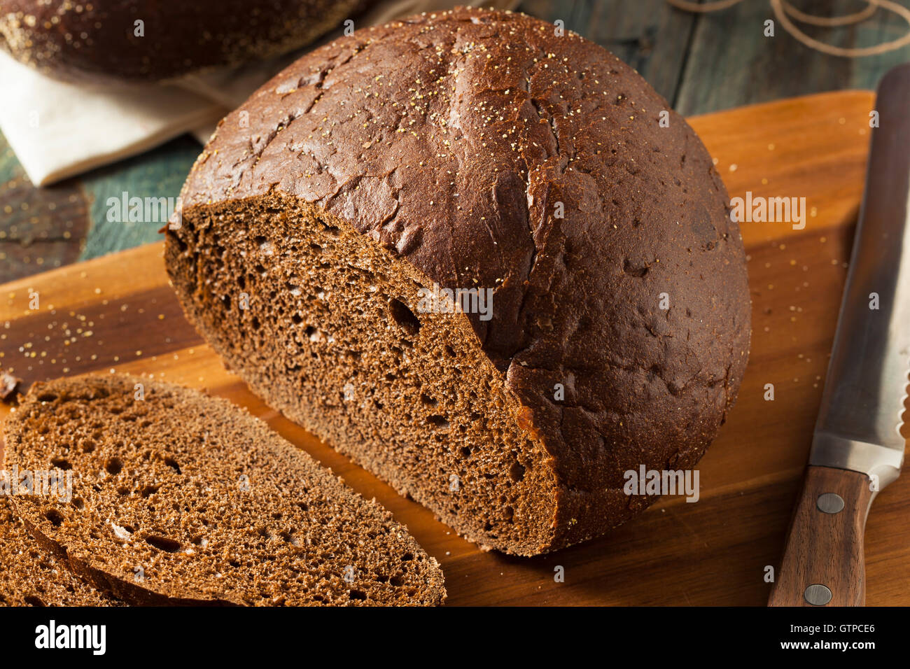 Homemade Organic Pumpernickel Rye Bread Cut into Slices Stock Photo