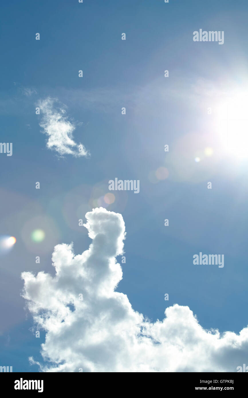 Dramatic clouds against a blue sky with lens flare from the sun Stock ...